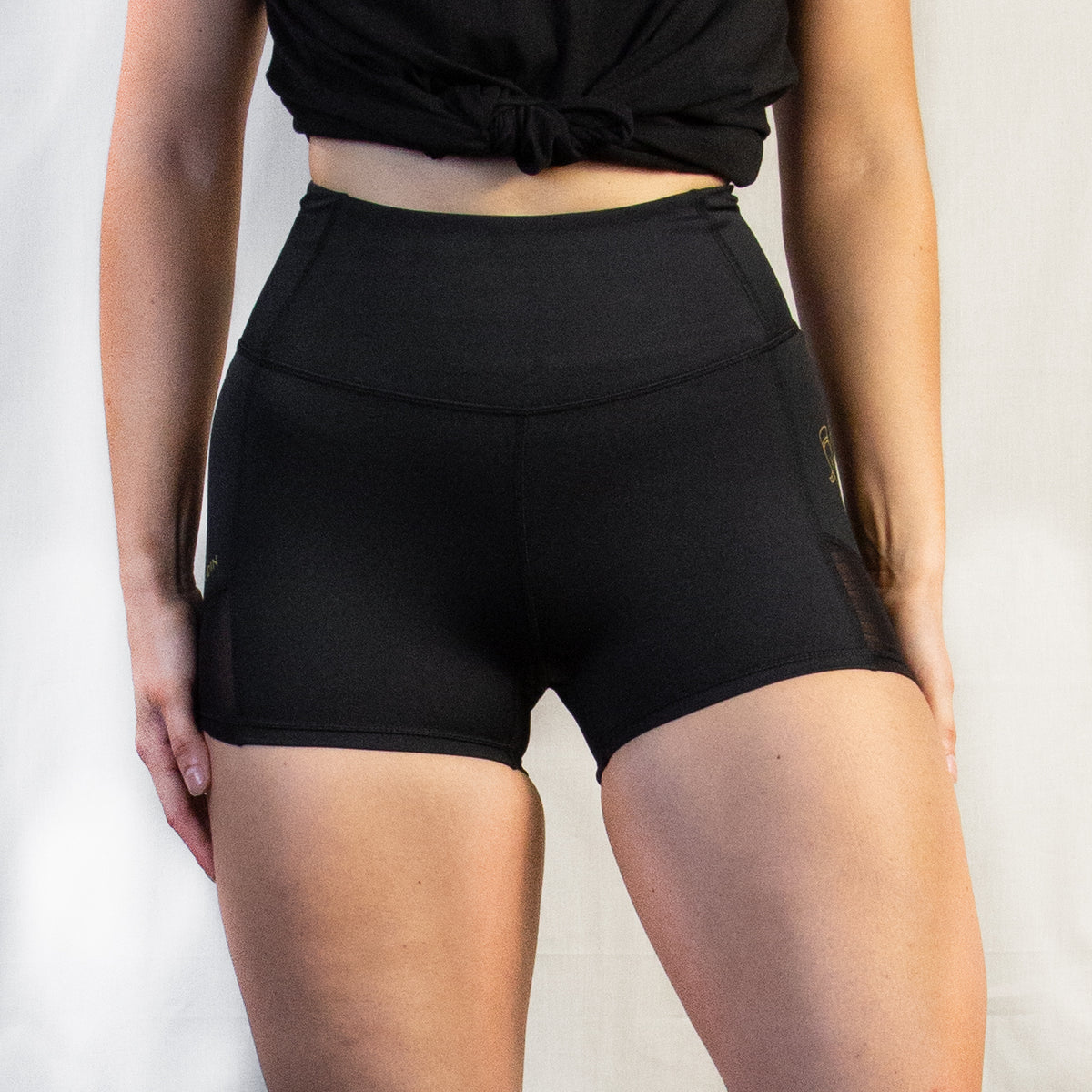 Women's Compression Shorts, Black performance gym shorts with gold detailing and mesh panelling