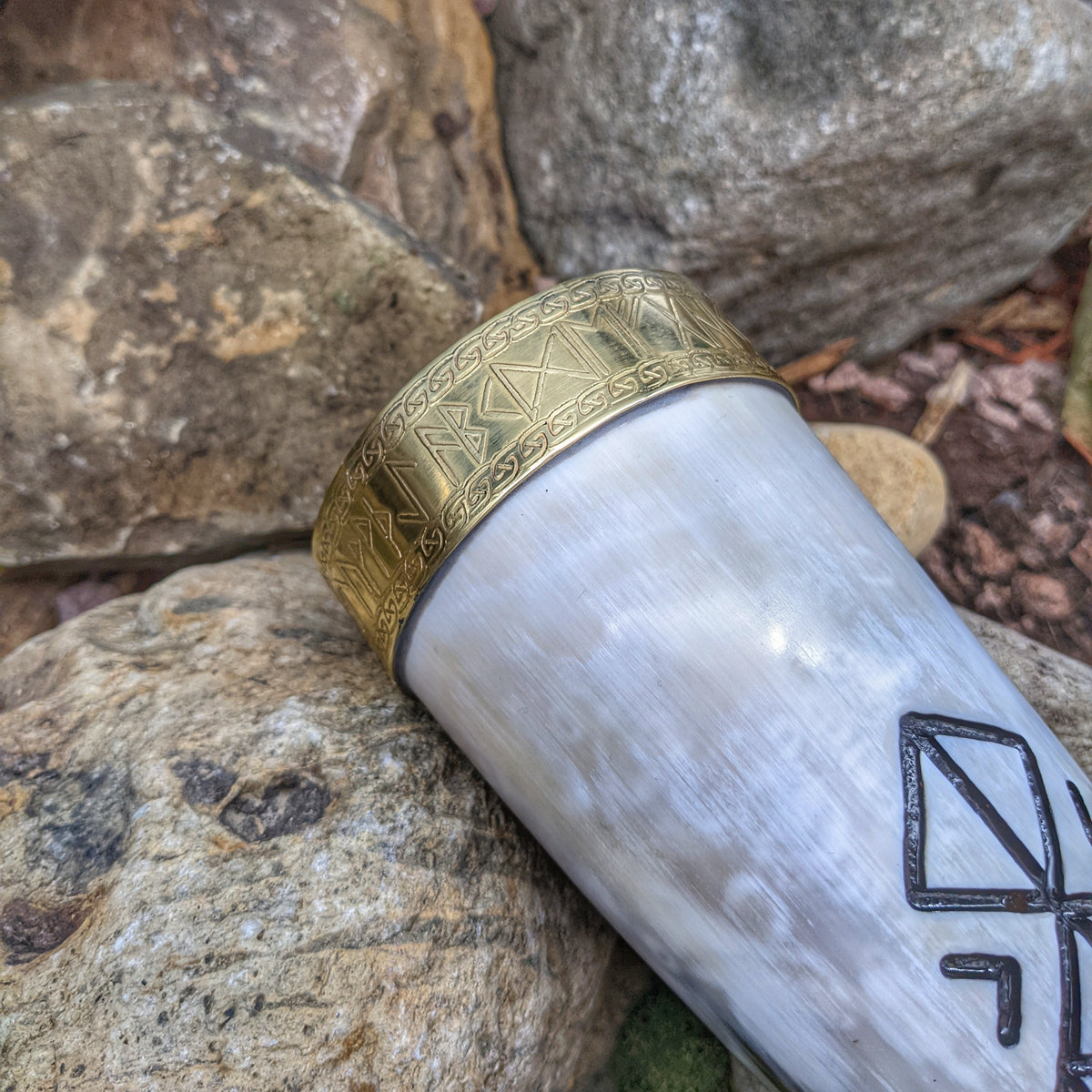 Close up of brass rune banded horn rim
